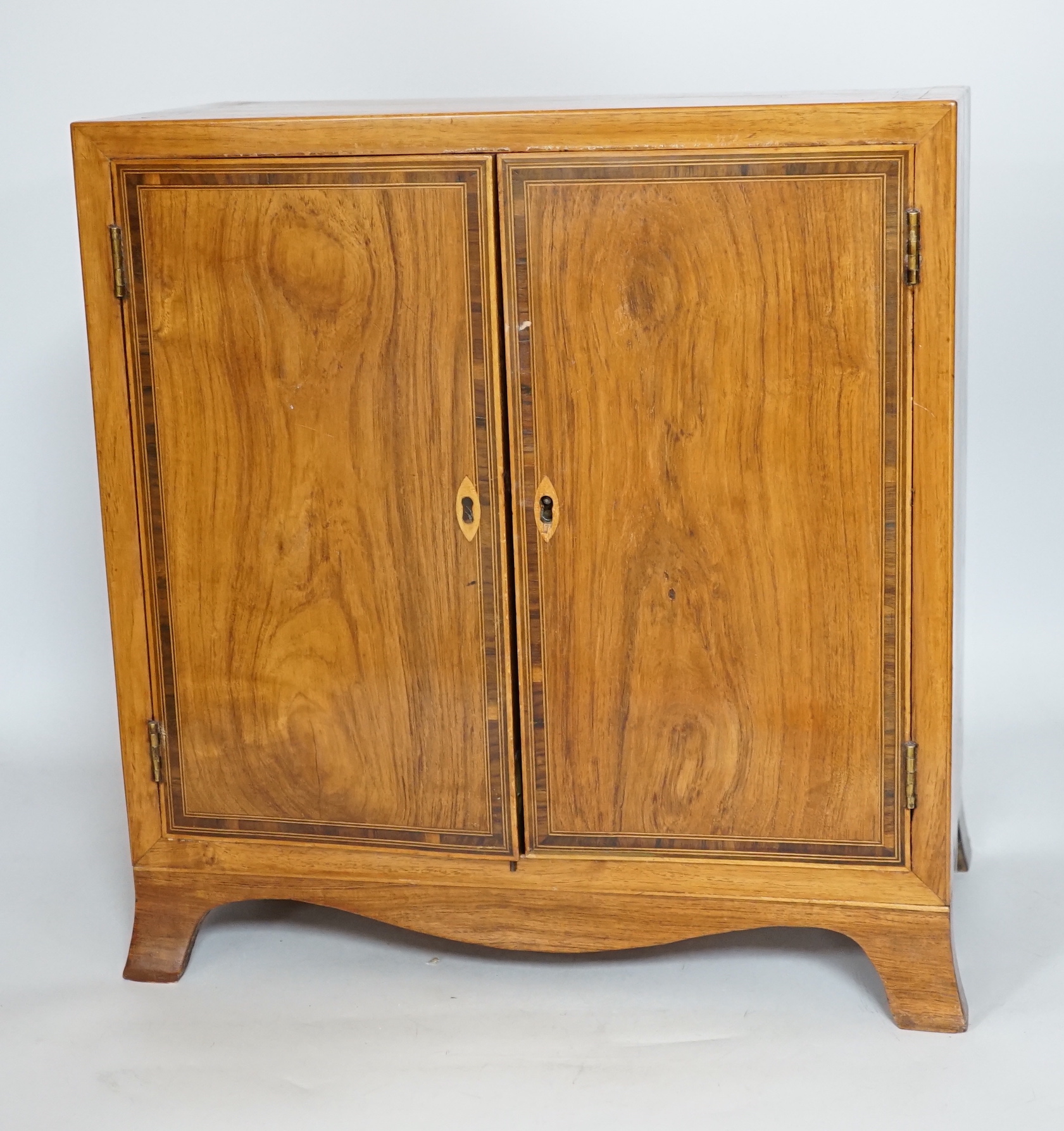 A George III style rosewood and tulipwood banded miniature two door chest, fitted with four graduated drawers, 36 x 35cm